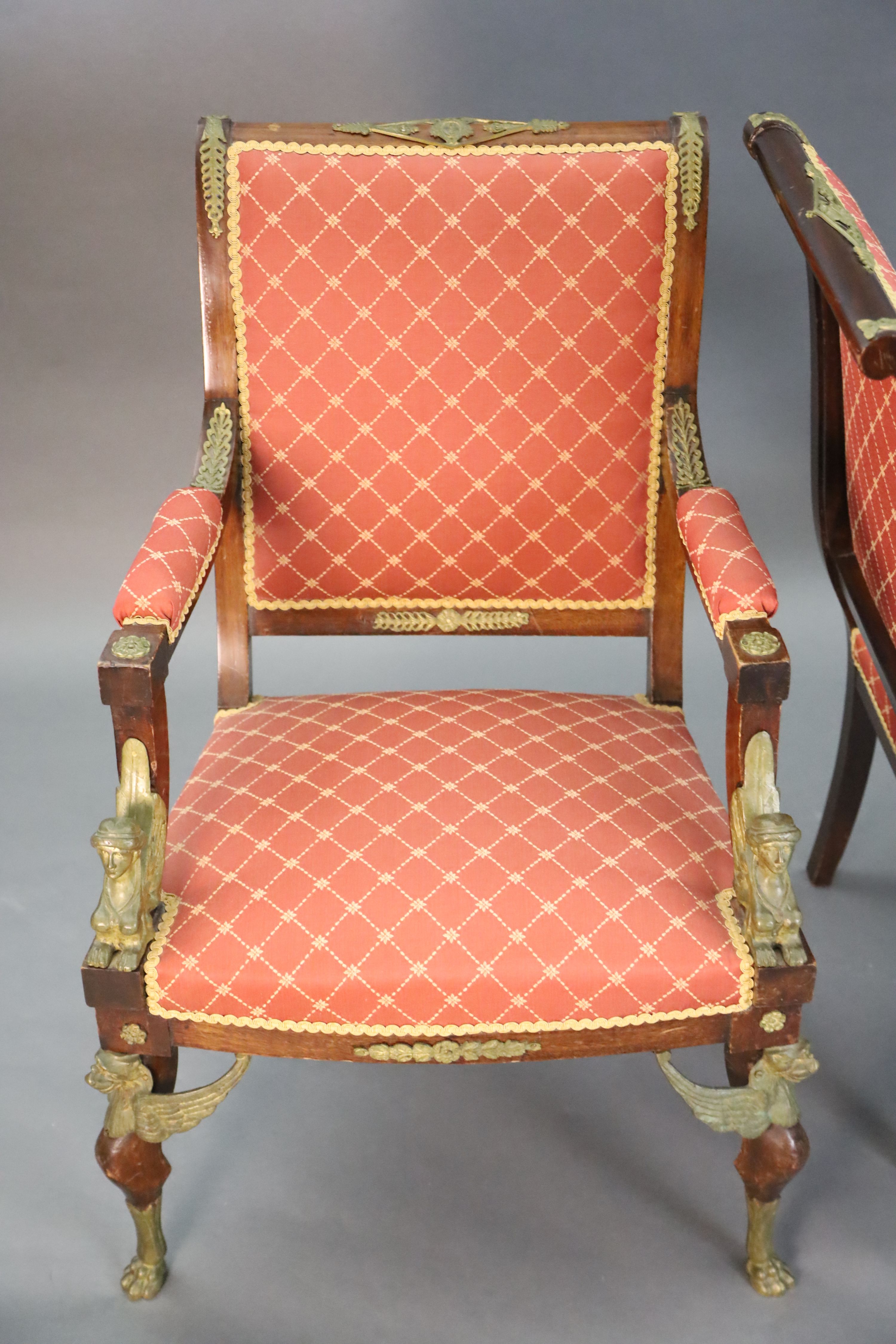 A late 19th century French Empire style ormolu mounted mahogany three piece salon suite, settee W.4ft 7in. D.2ft 5in. H.3ft 6in.